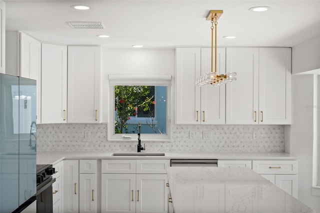 600 115th Ave, Treasure Island, FL 33706 - kitchen featuring white cabinetry, light stone countertops, and recessed lighting