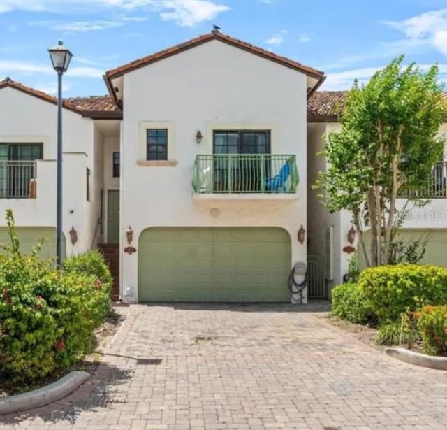 2924 Hidden Harbour Ct, Fort Lauderdale, FL 33312 - mediterranean / spanish home featuring a garage, stucco siding, a balcony, decorative driveway, and a tiled roof