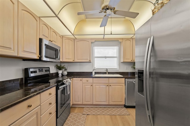 1230 Gulf Blvd Unit 1406, Clearwater Beach, FL 33767 - kitchen featuring stainless steel appliances, light wood-style flooring, light brown cabinets, a ceiling fan, and dark stone counters