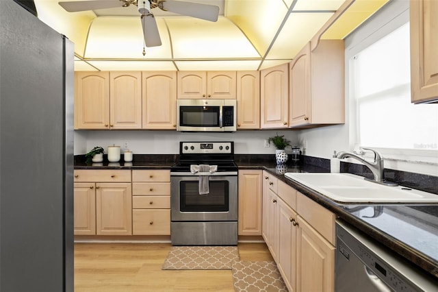 1230 Gulf Blvd Unit 1406, Clearwater Beach, FL 33767 - kitchen featuring stainless steel appliances, light wood-type flooring, dark countertops, and a ceiling fan