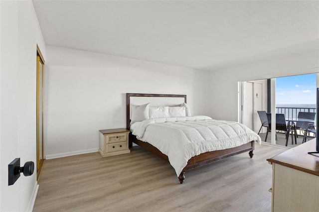 1230 Gulf Blvd Unit 1406, Clearwater Beach, FL 33767 - bedroom featuring access to exterior, light wood-style floors, and a water view