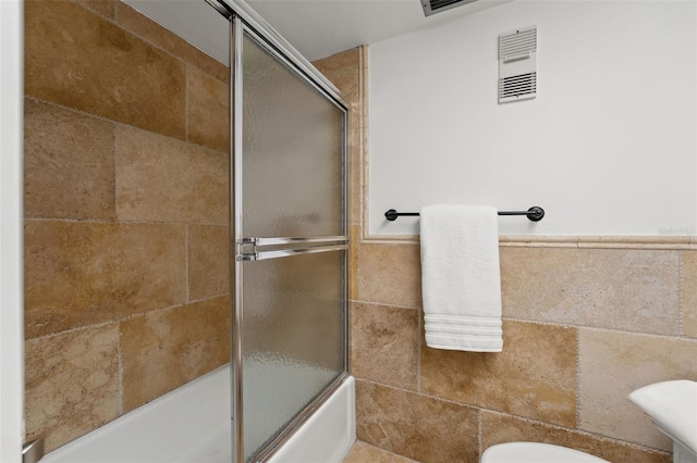 1230 Gulf Blvd Unit 1406, Clearwater Beach, FL 33767 - bathroom with toilet and bath / shower combo with glass door