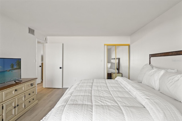 1230 Gulf Blvd Unit 1406, Clearwater Beach, FL 33767 - bedroom featuring light wood-type flooring and a closet
