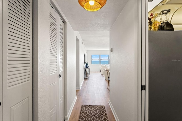1230 Gulf Blvd Unit 1406, Clearwater Beach, FL 33767 - corridor with wood finished floors and baseboards