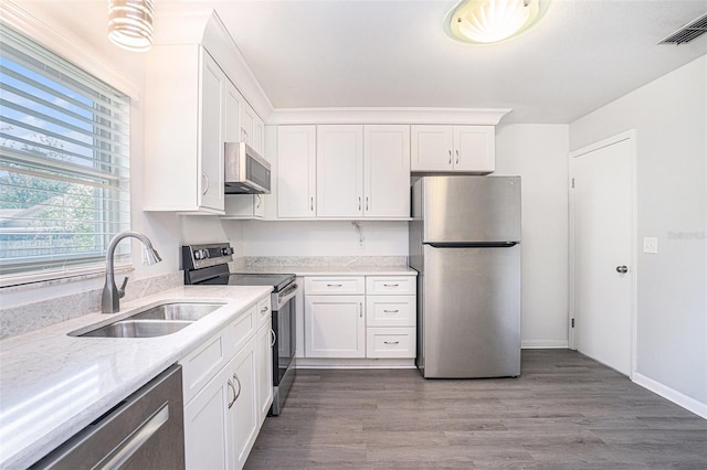 1902 Cedarbrooke Dr, Lutz, FL 33549 - kitchen with stainless steel appliances, white cabinetry, and wood finished floors