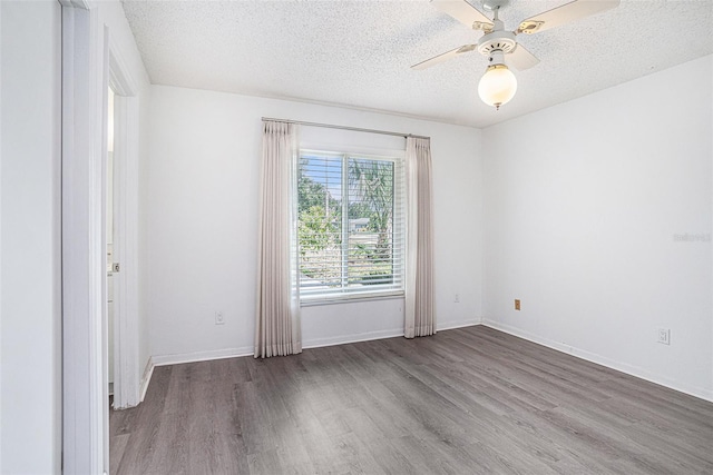 1902 Cedarbrooke Dr, Lutz, FL 33549 - spare room with wood finished floors, a textured ceiling, and a ceiling fan