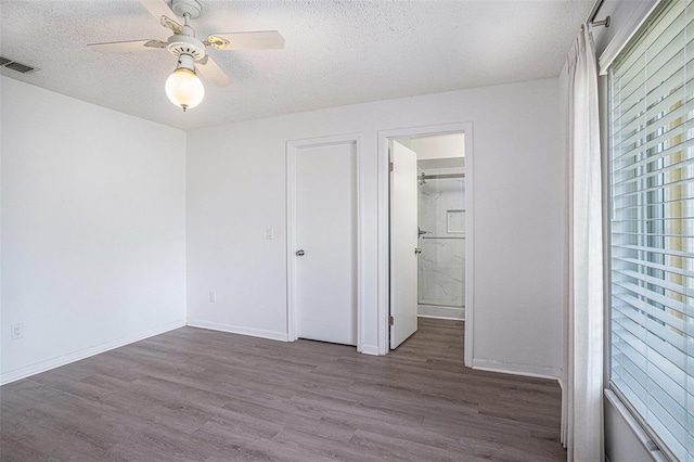 1902 Cedarbrooke Dr, Lutz, FL 33549 - unfurnished bedroom with a textured ceiling, wood finished floors, and a ceiling fan