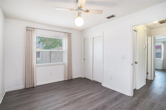 1902 Cedarbrooke Dr, Lutz, FL 33549 - unfurnished bedroom with wood finished floors, a textured ceiling, a closet, and ceiling fan