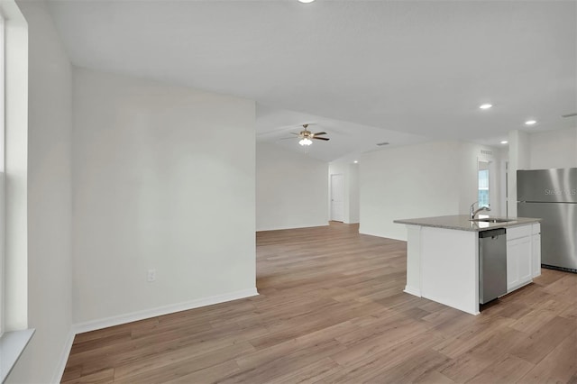 7504 SW 128th St, Ocala, FL 34473 - kitchen with a ceiling fan, appliances with stainless steel finishes, white cabinetry, light wood-type flooring, and recessed lighting