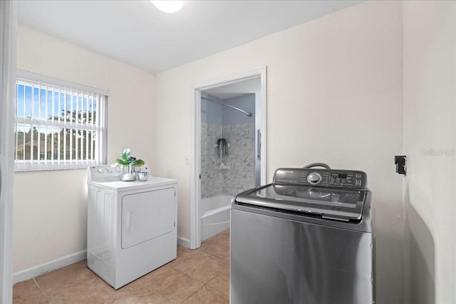 903 Tomahawk Trl, Brandon, FL 33511 - washroom featuring washer and dryer and light tile patterned flooring
