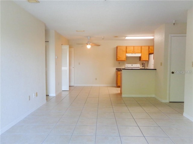 interior space featuring light tile floors, ceiling fan, and white refrigerator