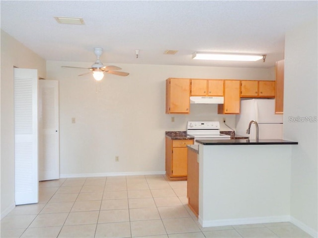 kitchen featuring light tile floors, ceiling fan, and white appliances