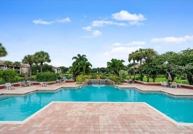 view of swimming pool with a patio area and pool water feature