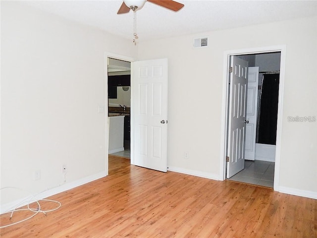 unfurnished room with ceiling fan and hardwood / wood-style floors