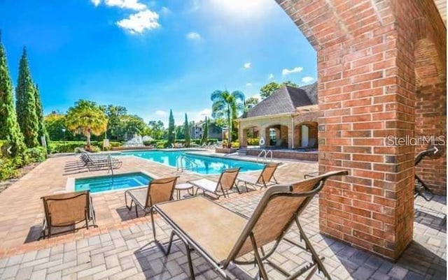 view of swimming pool with a patio area