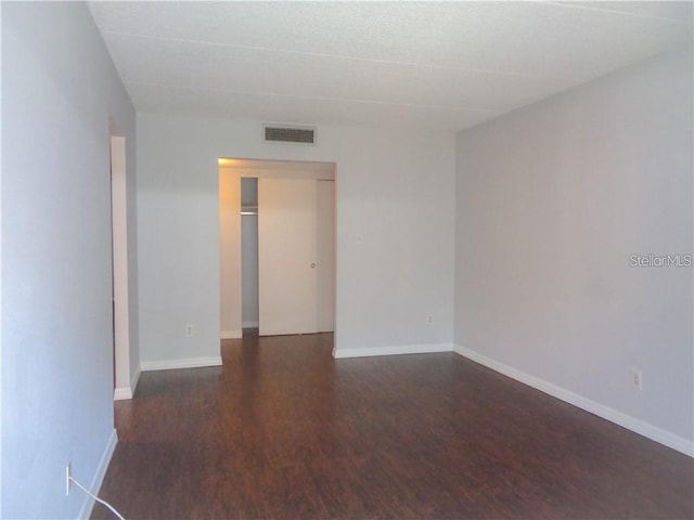 unfurnished room featuring dark hardwood / wood-style flooring