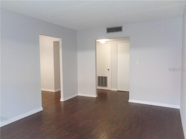 spare room featuring dark hardwood / wood-style floors