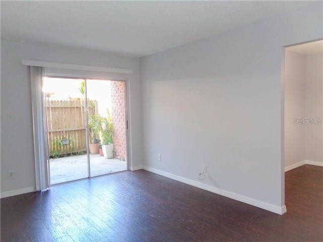 spare room featuring dark hardwood / wood-style floors