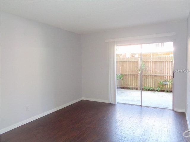 spare room featuring dark hardwood / wood-style floors