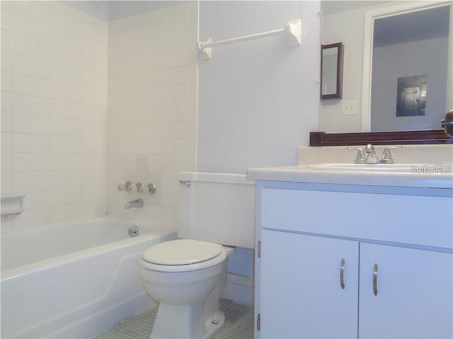 full bathroom with tile patterned floors, toilet, tiled shower / bath combo, and vanity