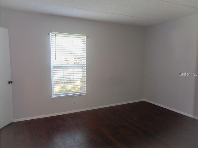 spare room featuring dark hardwood / wood-style flooring