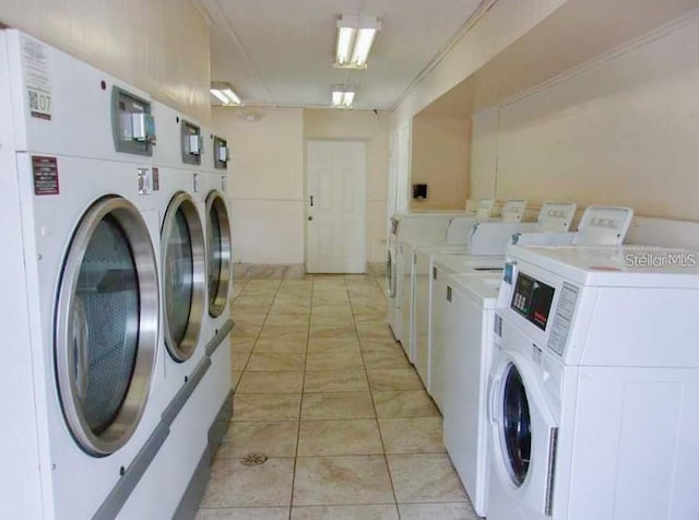 laundry room featuring light tile patterned flooring and separate washer and dryer