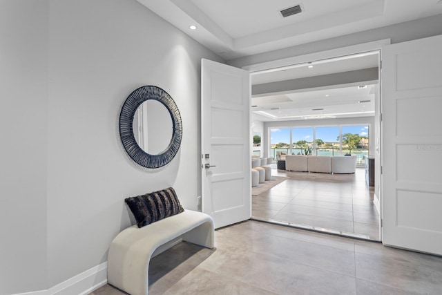 entrance foyer with a tray ceiling