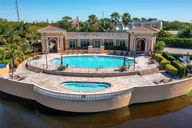 view of pool featuring a community hot tub and a patio