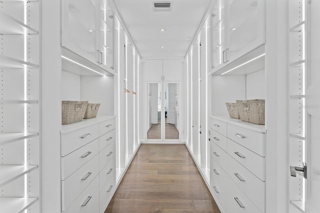 spacious closet with dark wood-type flooring