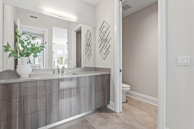 bathroom featuring vanity and toilet