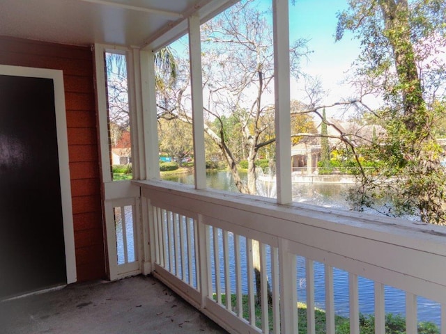 unfurnished sunroom with plenty of natural light and a water view