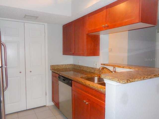 kitchen with kitchen peninsula, sink, light tile floors, light stone counters, and stainless steel dishwasher