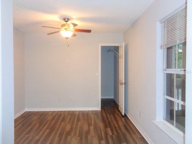 spare room with ceiling fan and dark hardwood / wood-style floors