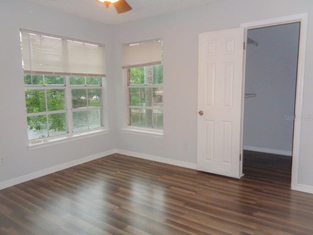 spare room featuring ceiling fan and dark wood-type flooring