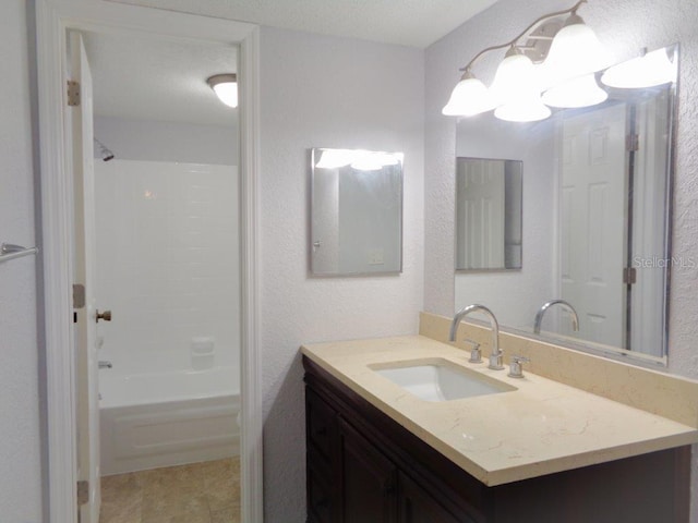 bathroom featuring shower / washtub combination, tile floors, and vanity