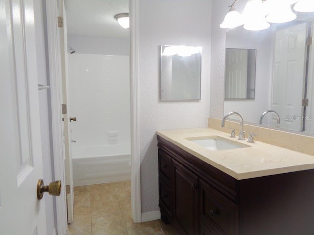 bathroom featuring vanity, tile floors, and washtub / shower combination