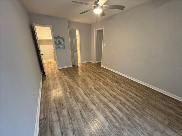 empty room featuring wood-type flooring and ceiling fan