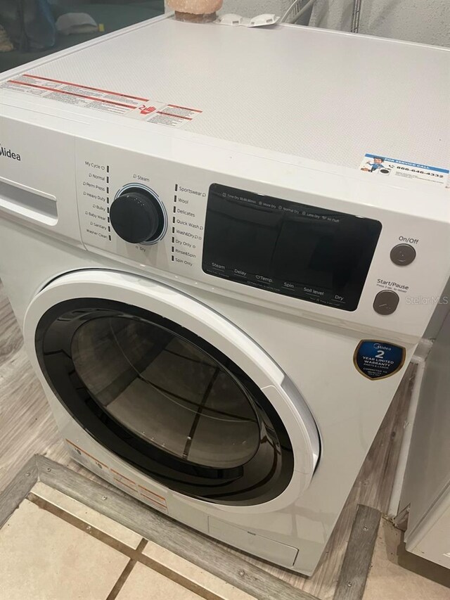 laundry room featuring washer / dryer and light tile patterned floors