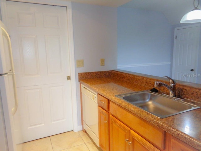 kitchen with light tile floors, white appliances, and sink