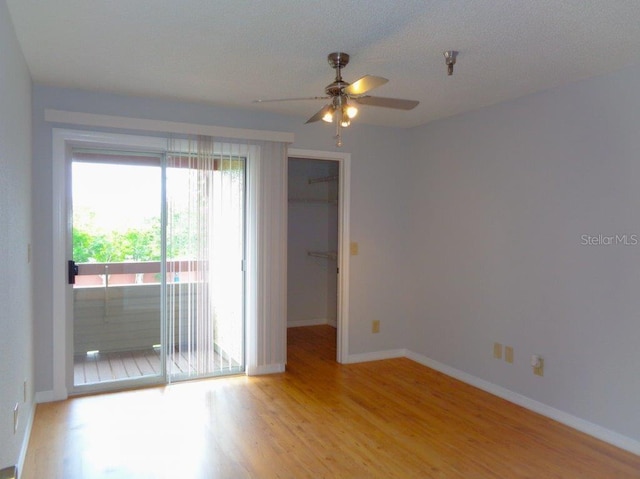 spare room featuring ceiling fan and light wood-type flooring