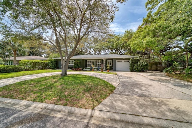 ranch-style home with a front yard and a garage