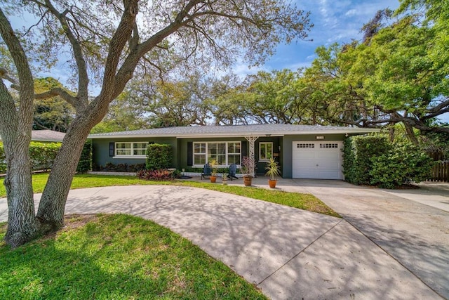 ranch-style home with a front yard and a garage