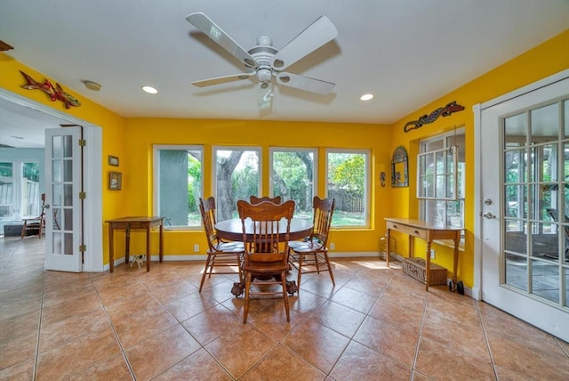 dining room with ceiling fan, light tile floors, and a wealth of natural light