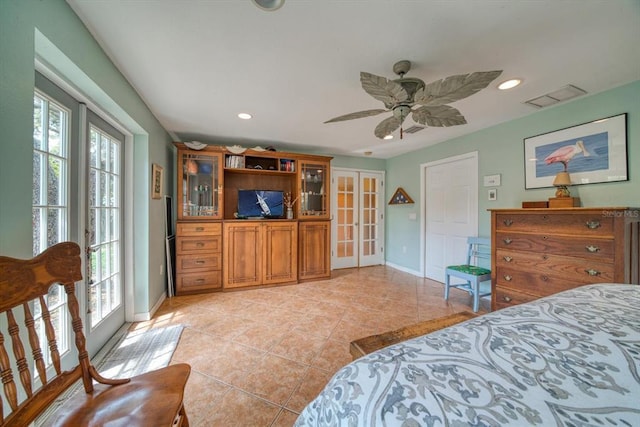 bedroom with french doors, multiple windows, ceiling fan, and light tile flooring