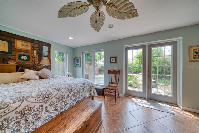 bedroom with light tile floors and access to outside