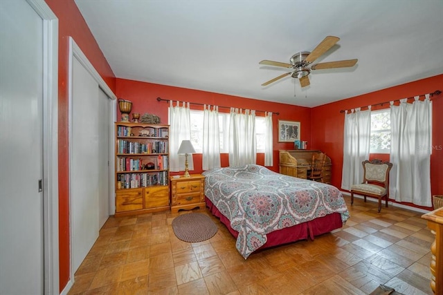 bedroom featuring light tile floors, a closet, and ceiling fan