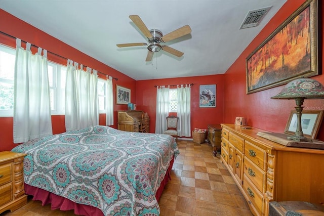 bedroom with ceiling fan and light tile flooring