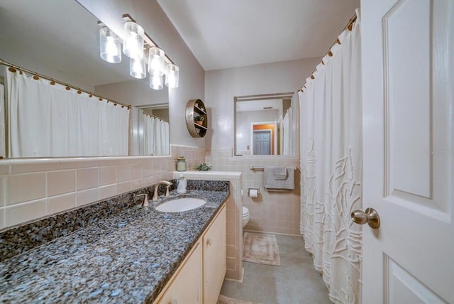 bathroom with tile walls, toilet, backsplash, tile flooring, and large vanity