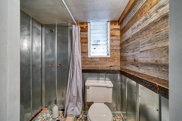 bathroom with wood walls and toilet