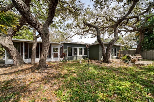 back of property with a sunroom